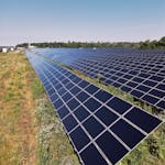 Wide view of a solar panel farm under a clear blue sky in Mississippi Mills, ON, promoting renewable energy.
